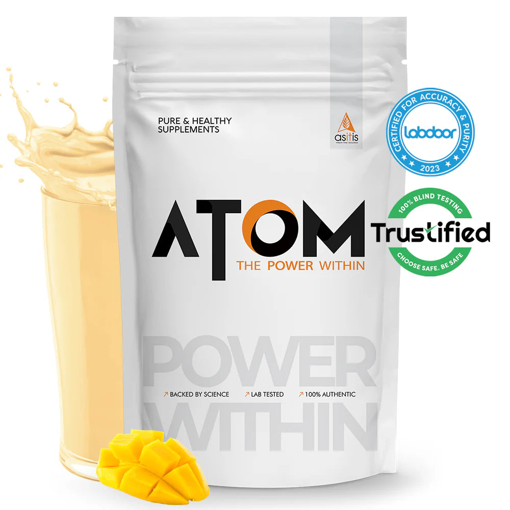 ATOM supplement package with a scoop of powder and mango pieces on a white background