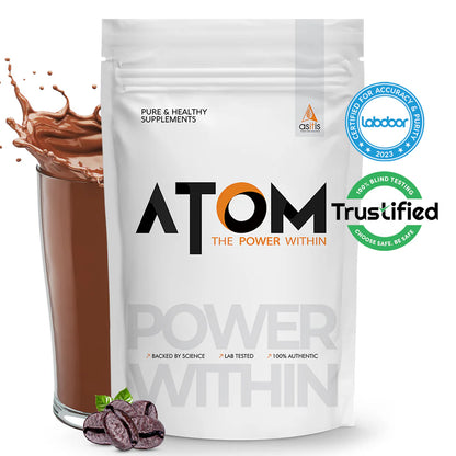 ATOM supplement package with a glass of chocolate shake and coffee beans on a white background