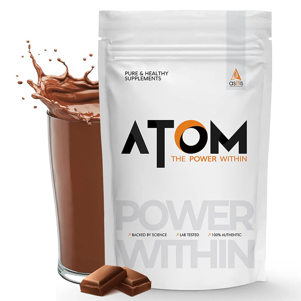 ATOM supplement package with a glass of chocolate drink and chocolate pieces on a white background