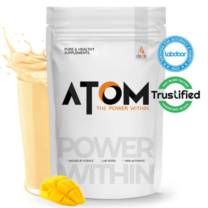 ATOM supplement package with a scoop of powder and mango pieces on a white background