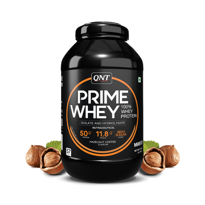 Black container of QNT Prime Whey protein with hazelnuts on a white background