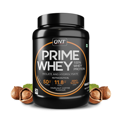 QNT Prime Whey protein powder container with hazelnuts on a white background