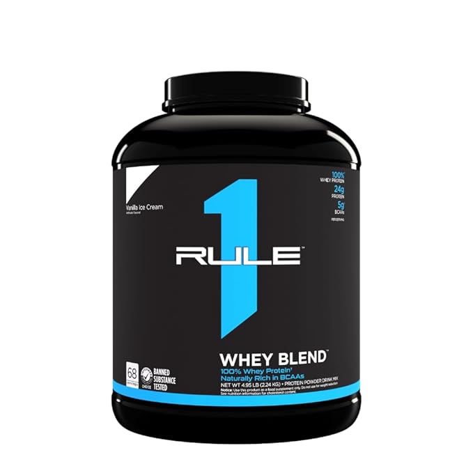 Black container of Rule 1 Whey Blend protein powder on a white background